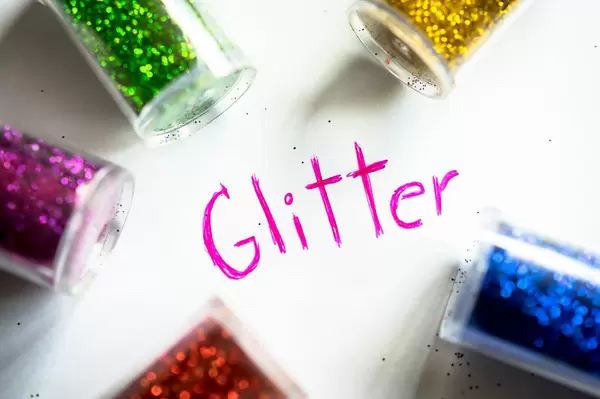 GLITTER word with glitter bottles around it