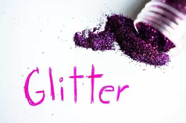 GLITTER written on a white paper