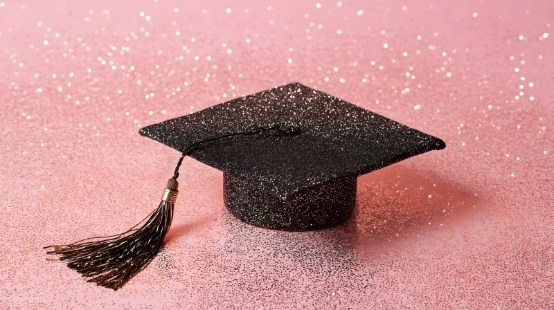 Glitzernde Abschlusskappe auf rosa Hintergrund mit Quaste