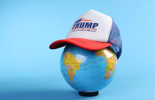 Globe wearing a Trump trucker hat