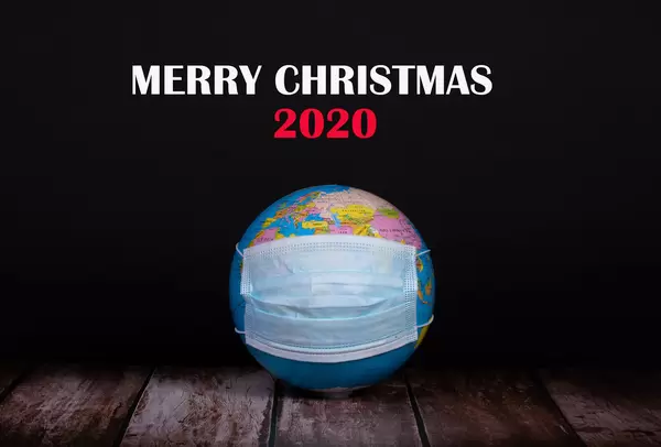 Globe with face mask and Merry Christmas 2020 text