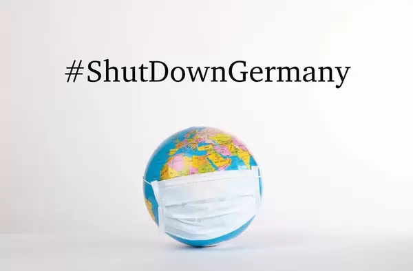 Globe with medical mask and #ShutDownGermany text on white background