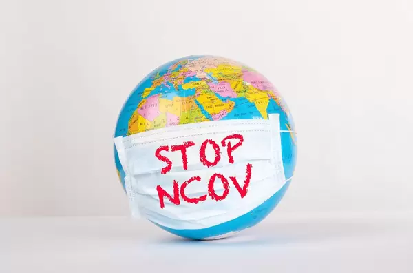 Globe with medical mask and Stop NCOV text