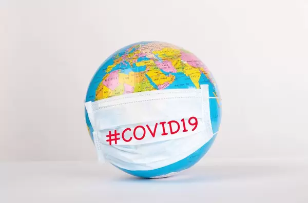 Globe with medical mask on white background with #COVID19 text.jpg