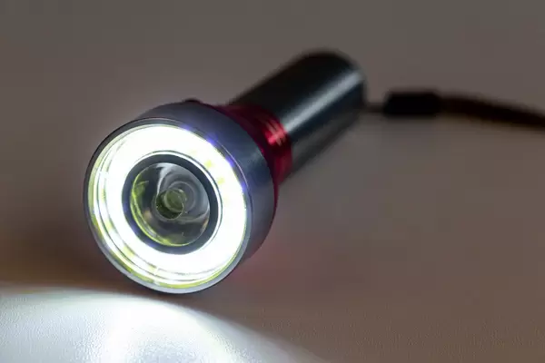 Glowing flashlight on a dark background