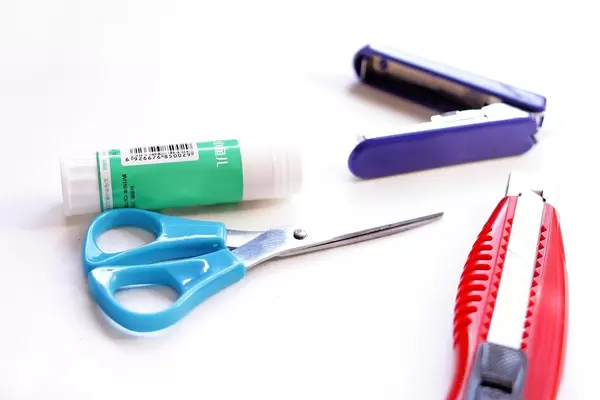 Glue, scissors and a knife isolated on white background