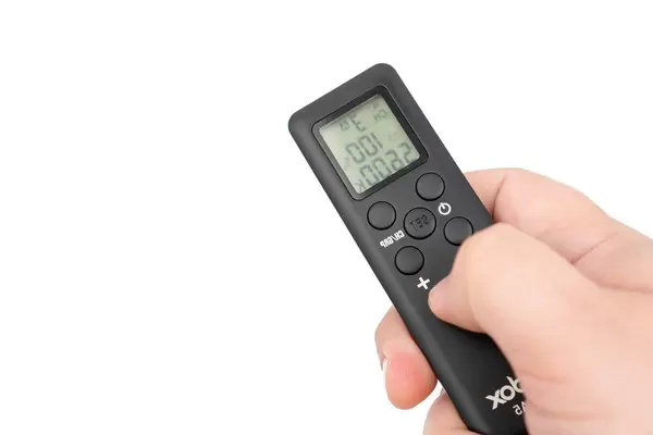 Godox remote controller for Led reflectors in the hand with copy space (Flip 2020)