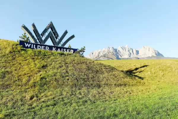 Going am Wilden Kaiser logo with Wilder Kaiser on background, Austria