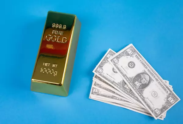 Gold brick with dollar banknotes