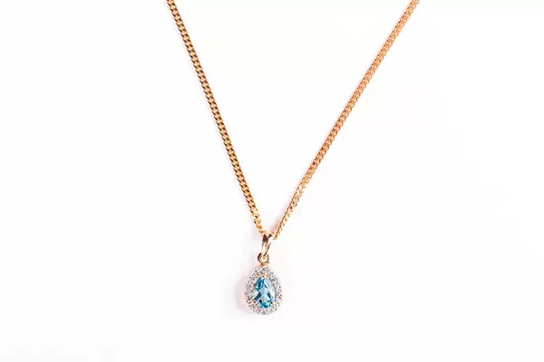 Gold chain and pendant on white background