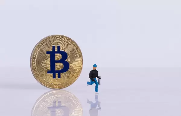 Golden Bitcoin and robber on white background