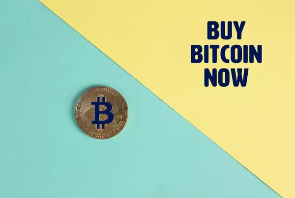 Golden Bitcoin coin and Buy Bitcoin Now text