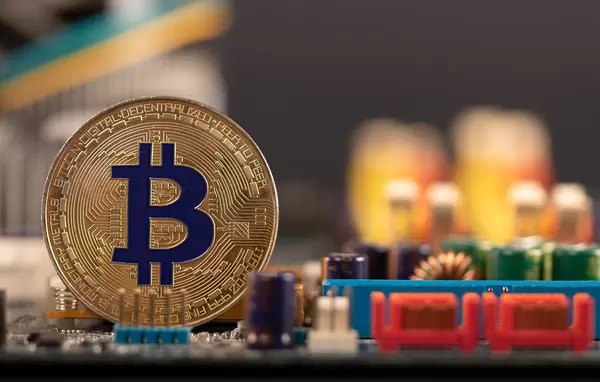Golden Bitcoin on computer parts background