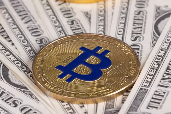 Golden Bitcoin on money bills