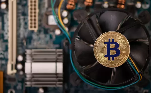 Golden Bitcoin on the computer motherboard