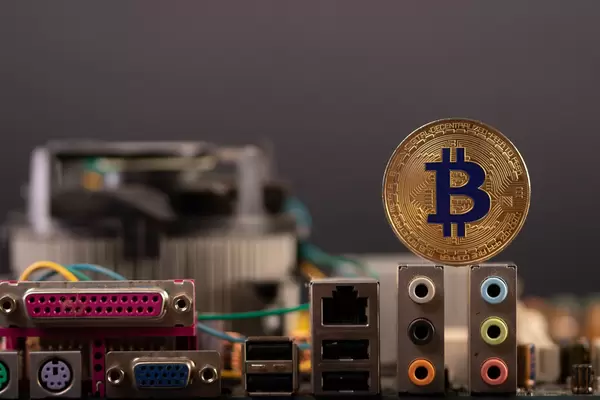 Golden Bitcoin with computer parts