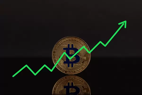 Golden Bitcoin with green arrow on black background