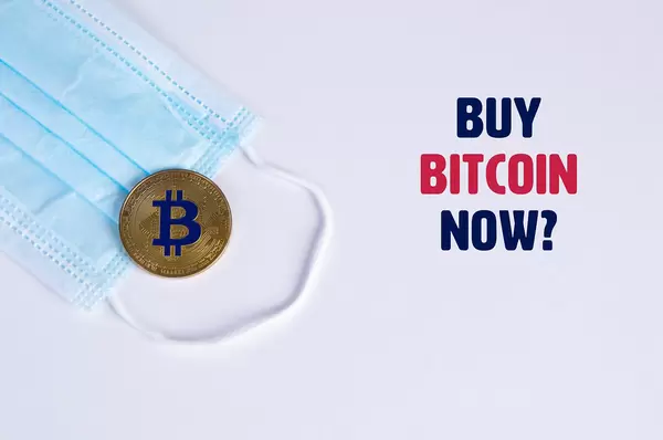 Golden Bitcoin with protective face mask and Buy Bitcoin Now text
