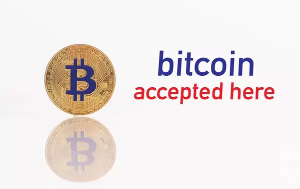 Golden Bitcoin with text Bitcoin accepted here