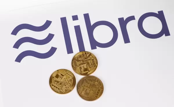 Golden coins with Libra cryptocurrency logo