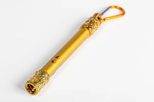 Golden laser pointer on a white background