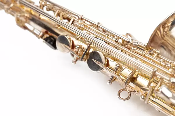 Golden Metal Saxophone playing buttons above white