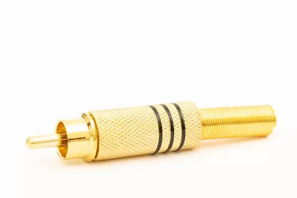 Golden RCA connector for audio cable isolated above white background