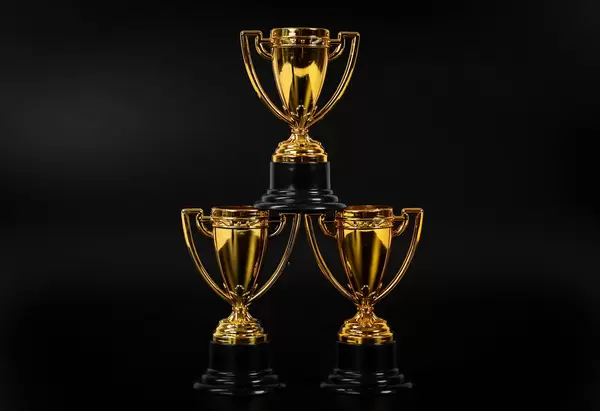 Golden trophies on black background