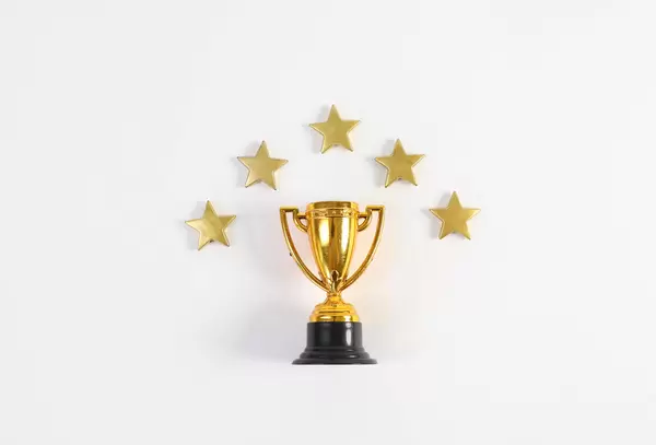 Golden trophy with stars on white background