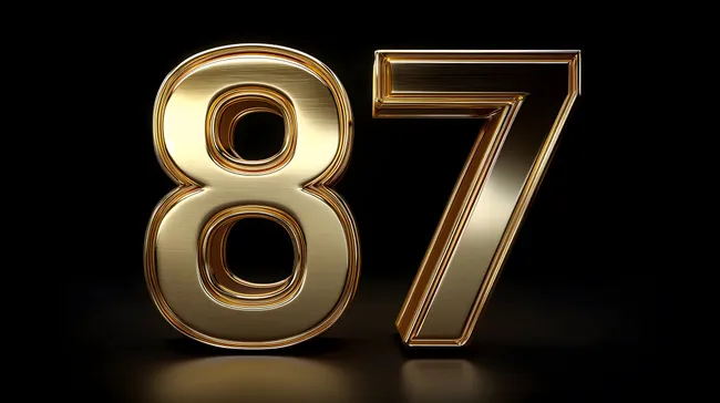 Goldene, edel-glänzende Zahl 87 auf schwarzem Hintergrund