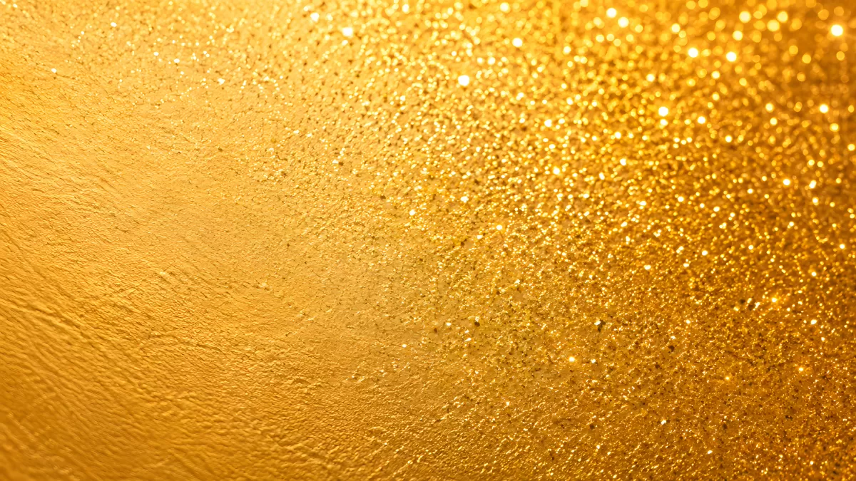 Goldglitzernde Oberfläche mit funkelnden Lichtreflexen