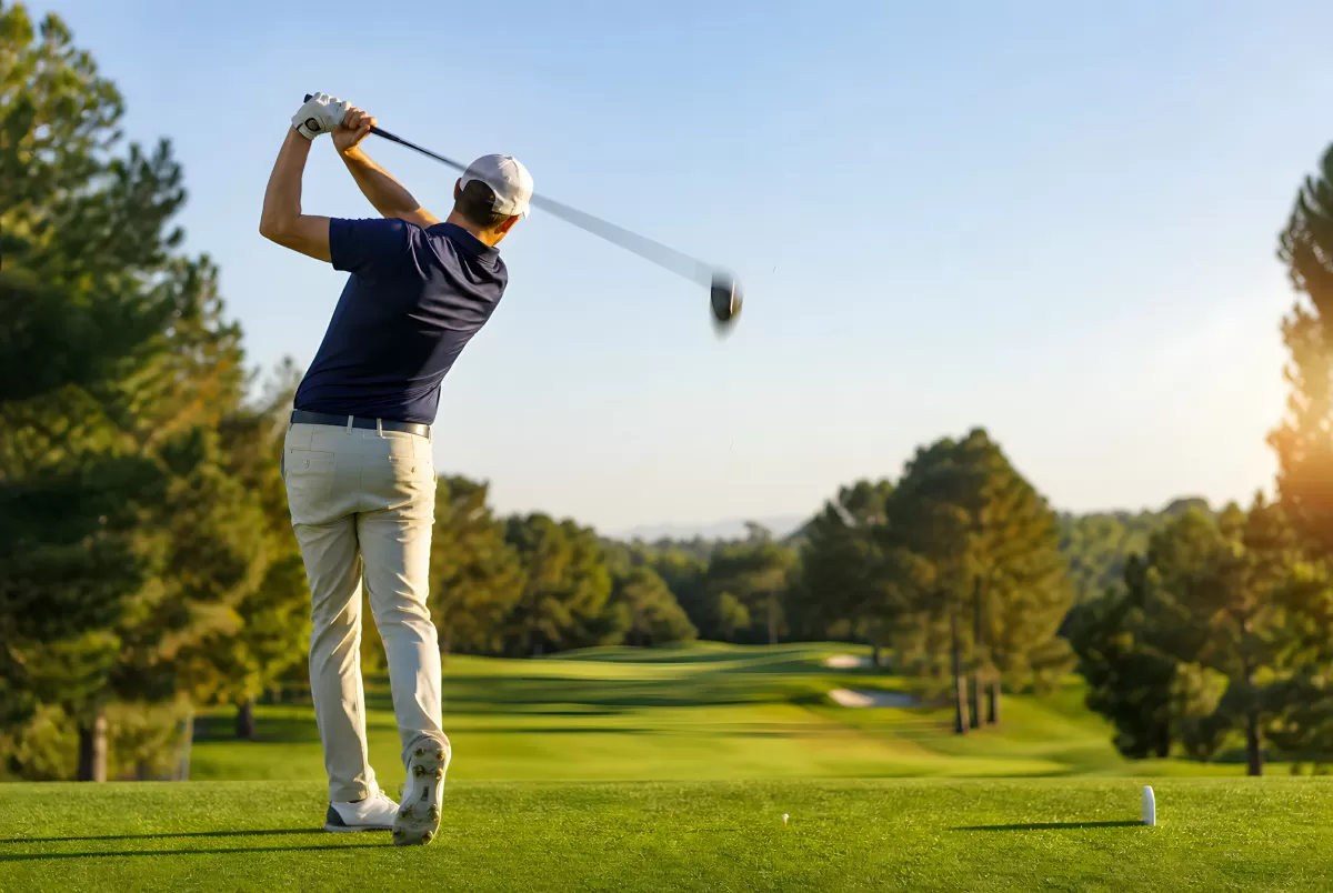 Golfspieler beim Abschlag auf sonnigem Golfplatz