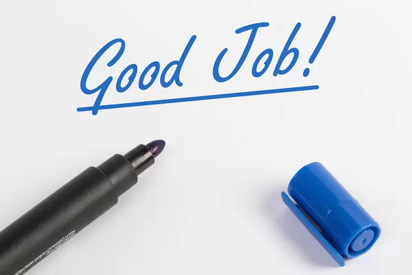 Good Job text with blue marker pen