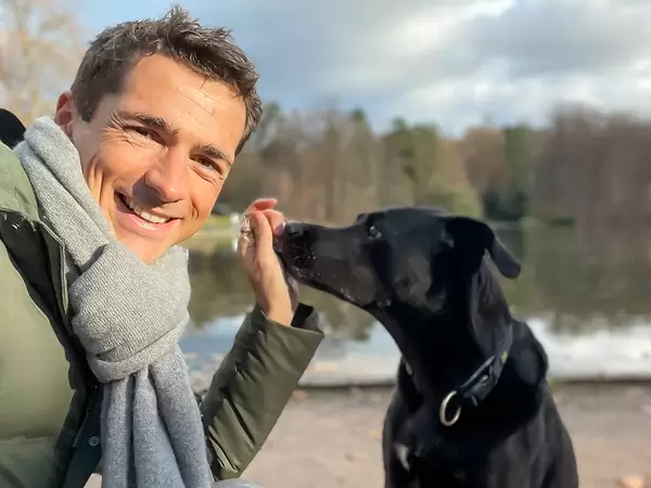 Good times, good mood while taking the dog for a walk at the lake on a cold day