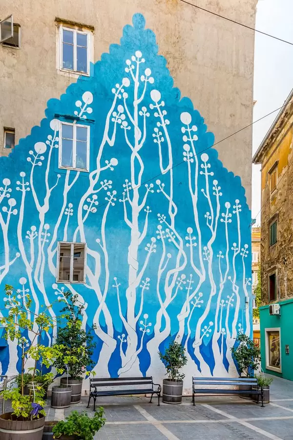 Graffiti on the wall - trees on old building