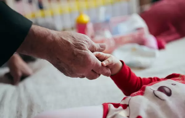 Grandfather and grandaughter shaking hands