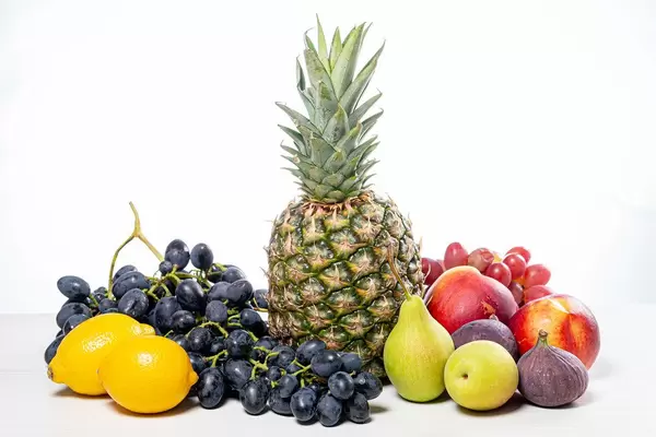 Grapes, pineapple, pears, apples, nectarine, figs and lemons on white background (Flip 2019)