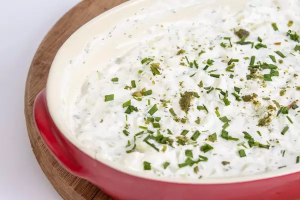 Grated Cucumber with Onions and Sour Cream in the bowl