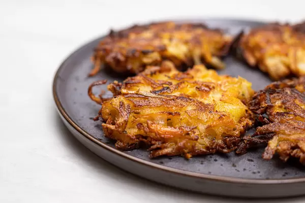 Grated Potatoes and Carrots Fritters served on the plate