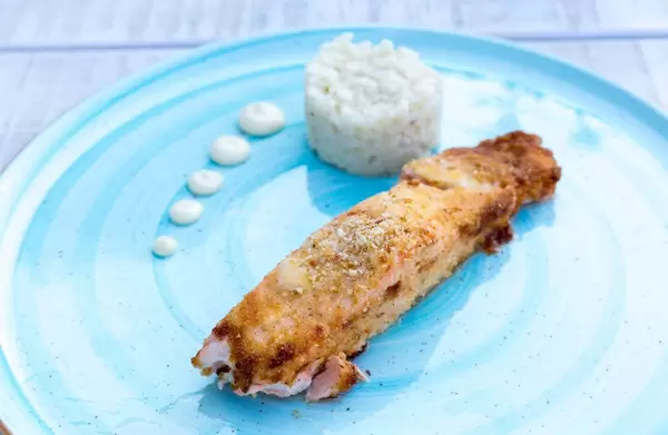 Gratinated salmon with parmesan crust, dark rice and wasabi mayonnaise