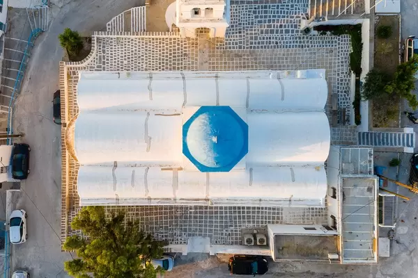 Greek architecture seen from the air: the white church of Agios Charalambos with the blue dome