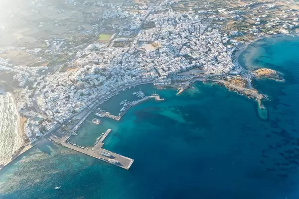Greek islands: aerial view of the city of Naxos (Chora), its port and the beach of Agios Georgios