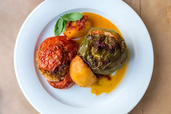 Greek lunch "Gemista": colorful, stuffed peppers and tomatoes, rice, mint, pine nuts and raisins