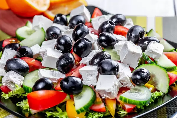 Greek salad with fresh vegetables, feta cheese and black olives. Top view  Flip 2019