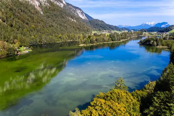 Green-blue waters and trees with red-yellow leaves. Autumn aerial view of lake Reintal in Austria