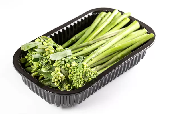 Green broccolini in a plastic container