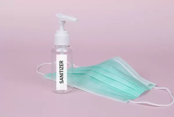 Green face mask with sanitizer bottle