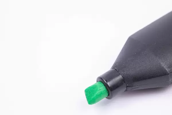 Green Felt Pen above white background with copy space