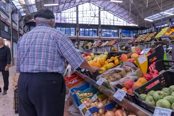 Green grocer selling vegetables and fruits in Timeout Market Lisbon