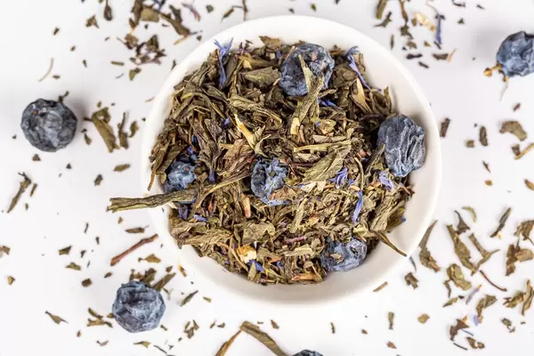 Green herbal tea with dried blackthorn berries